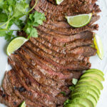 Pinterest pin with the image of sliced carne asada steak on a platter.
