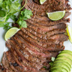 Pinterest pin with text overlay "Carne Asada" with the image of sliced carne asada steak on a platter.