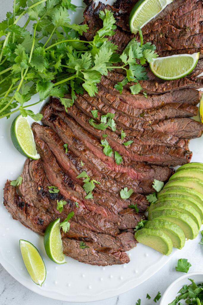 Carne asada sliced into strips on a platter.