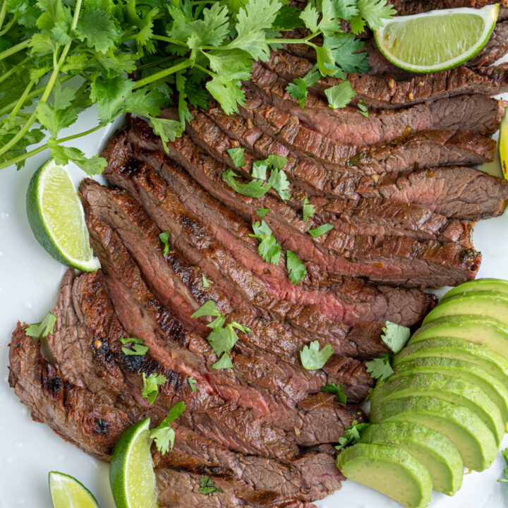 Carne asada sliced into strips on a platter.