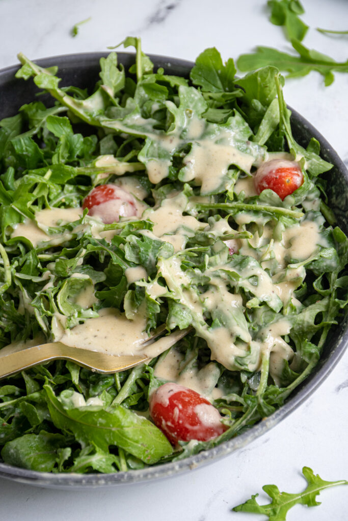 Fresh greens covered in creamy hummus salad dressing.