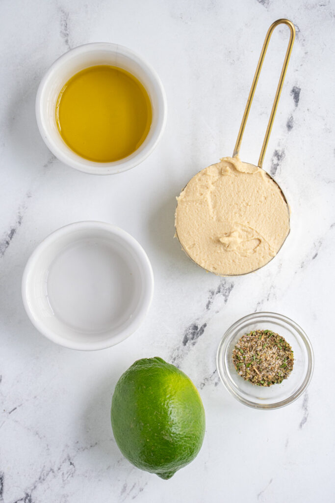 Ingredients to make Hummus Salad Dressing laid out on a table top.