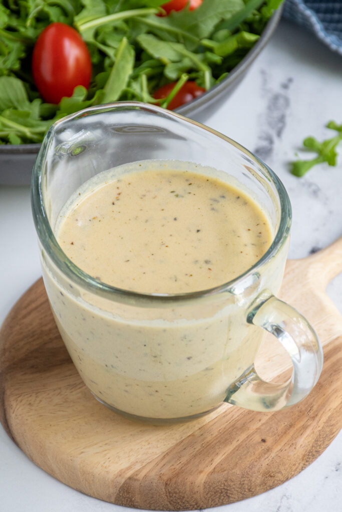 A serving dish filled with creamy hummus salad dressing.