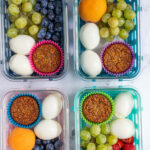 Pinterest pin with text overlay "Breakfast Bistro Box", image of four breakfast bistro boxes with eggs, muffin, and fruit.