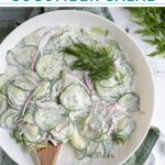 Pinterest Pin with text overlay "Creamy Cucumber Salad" image of a white bowl filled with creamy cucumber salad with dill.