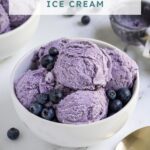 Pinterest pin with text overlay "Homemade Blueberry Ice Cream", image of a bowl with scoops of blueberry ice cream and fresh blueberries.