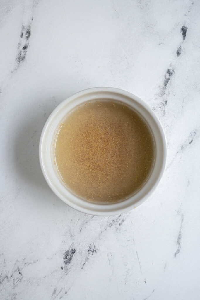Water and flax seed in a bowl making a flax seed egg, a vegan alternative.