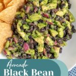 Pinterest Pin with text overlay "Avocado Black Bean Salsa", image of a white bowl with black bean avocado salsa and tortilla chips.