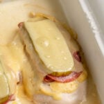 Pinterest pin with text overlay "Cubano Chicken, like the sandwich bur baked on chicken", image of a chicken breast topped with cuban sandwich toppings and baked.