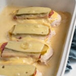 Pinterest pin with text overlay "Cubano Chicken, like the sandwich bur baked on chicken", image of a chicken breast topped with cuban sandwich toppings and baked.