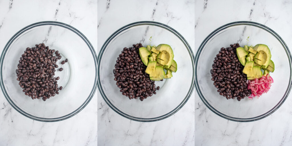 The first steps to making avocado black bean salsa by adding beans, avocado, and pickled red onions to a bowl.