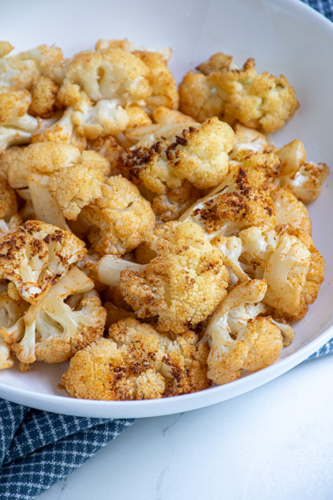 Crispy air fryer cauliflower in a white bowl.