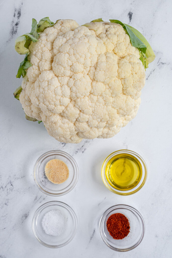 Ingredients to make sire fryer cauliflower laid out on a tabletop.