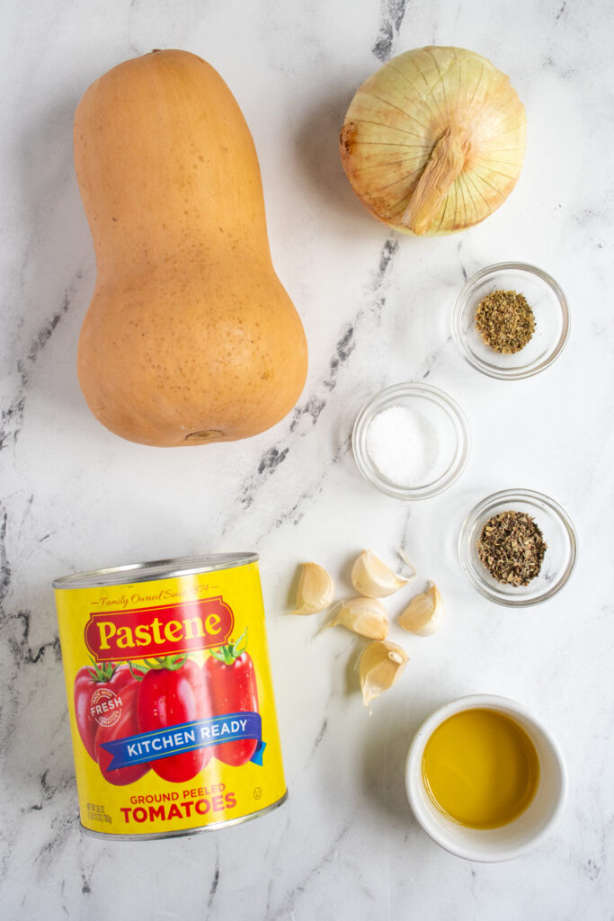 Ingredients to make butternut squash pasta sauce laid out on a table top.