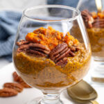 Pinterest Pin with text overlay "Pumpkin Chia Seed Pudding", image of a glass with pumpkin chia seed pudding topped with pecans.