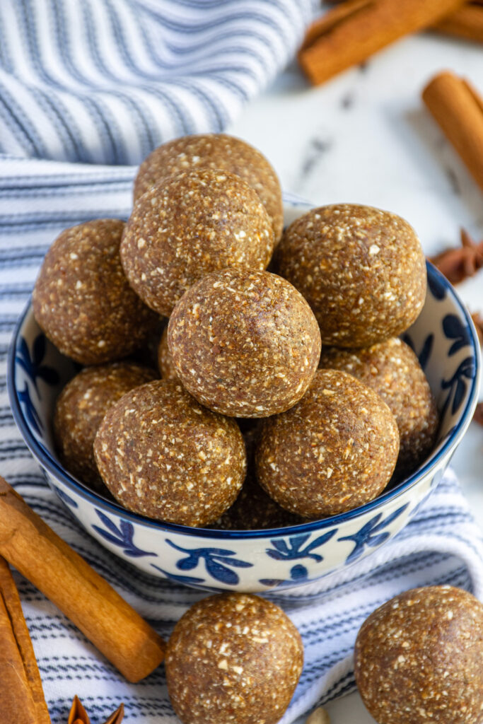 Close up of chai spiced energy balls in a blue and white bowl.