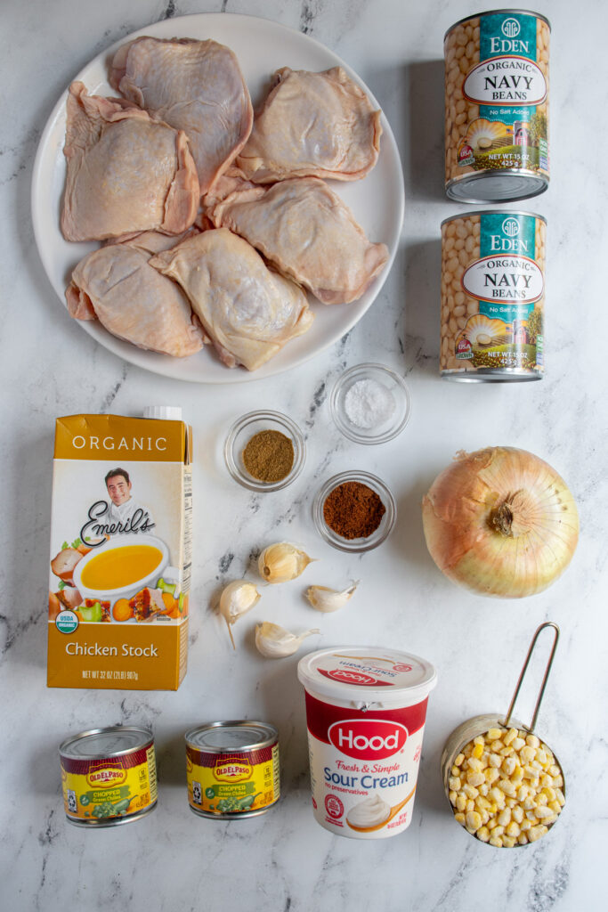 Ingredients for making crockpot white chicken chili laid out on a tabletop.