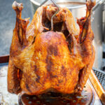 Pinterest pin with text overlay 'The Best Deep Fried Turkey Recipe', image of a golden brown deep fried turkey.