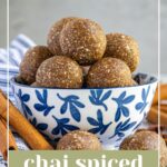 Pinterest pin with text overlay "Chai Spiced Energy Ball", image of a blue and white bowl overfilled with chai spiced energy bites.