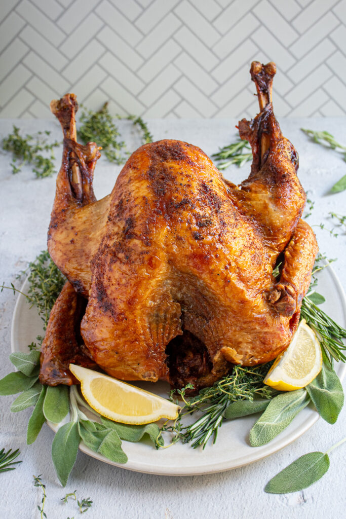 A platter with the best deep fried turkey with crispy golden skin.
