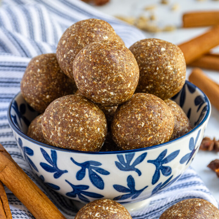 A blue and white bowl filled with chai spice energy bites.