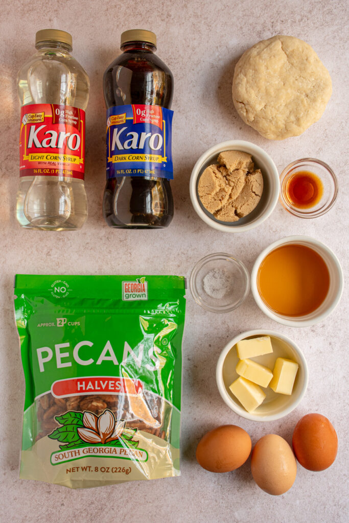 Ingredients to make bourbon pecan pie laid out on a tabletop.