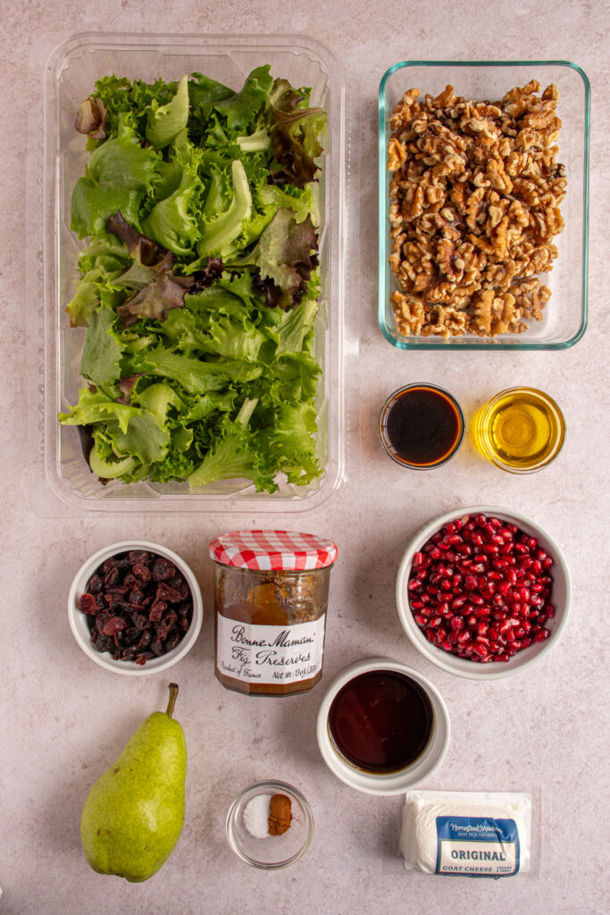 Ingredients for a winter salad laid out on a table top.