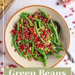 Pinterest pin with text overlay "Green Beans with Pomegranate & Pistachios", image of a bowl of bright green beans with red pomegranate seeds and pistachios.