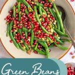Pinterest pin with text overlay "Green Beans with Pomegranate", image of a bowl of bright green beans with red pomegranate seeds and pistachios.