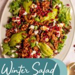 Pinterest pin with text overlay 'Winter Salad with Candied Walnuts', image of a large platter covered in a colorful and festive salad.