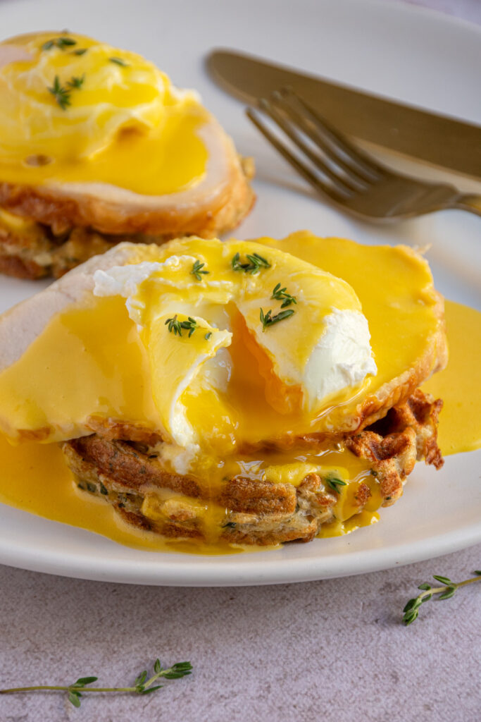 A stuffing waffle topped with turkey, a poached egg, and hollandaise sauce to make a Thanksgiving eggs benedict.