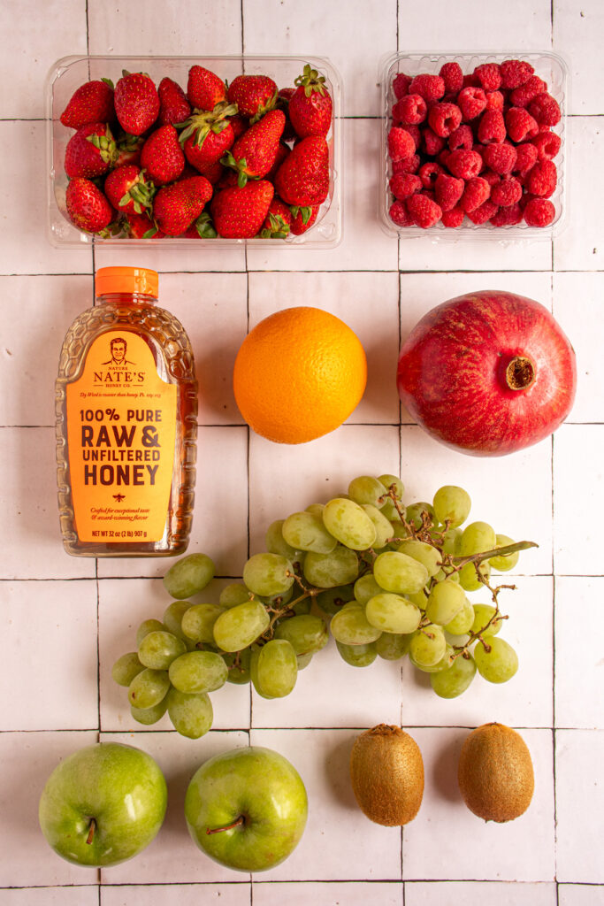 Ingredients to make Christmas fruit salad on a table top.