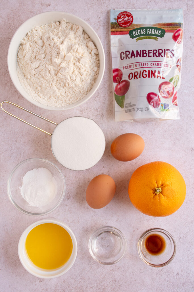Ingredients to make Orange Cranberry Biscotti laid out on a tabletop.