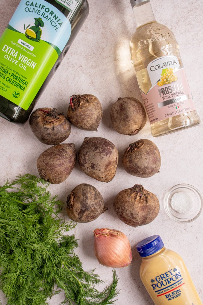 Ingredients needed to make simple beet salad laid out on a table top.