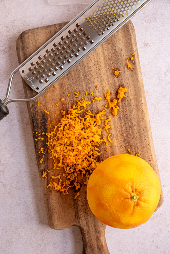 Orange zest on a cutting board to make Orange Cranberry Biscotti.