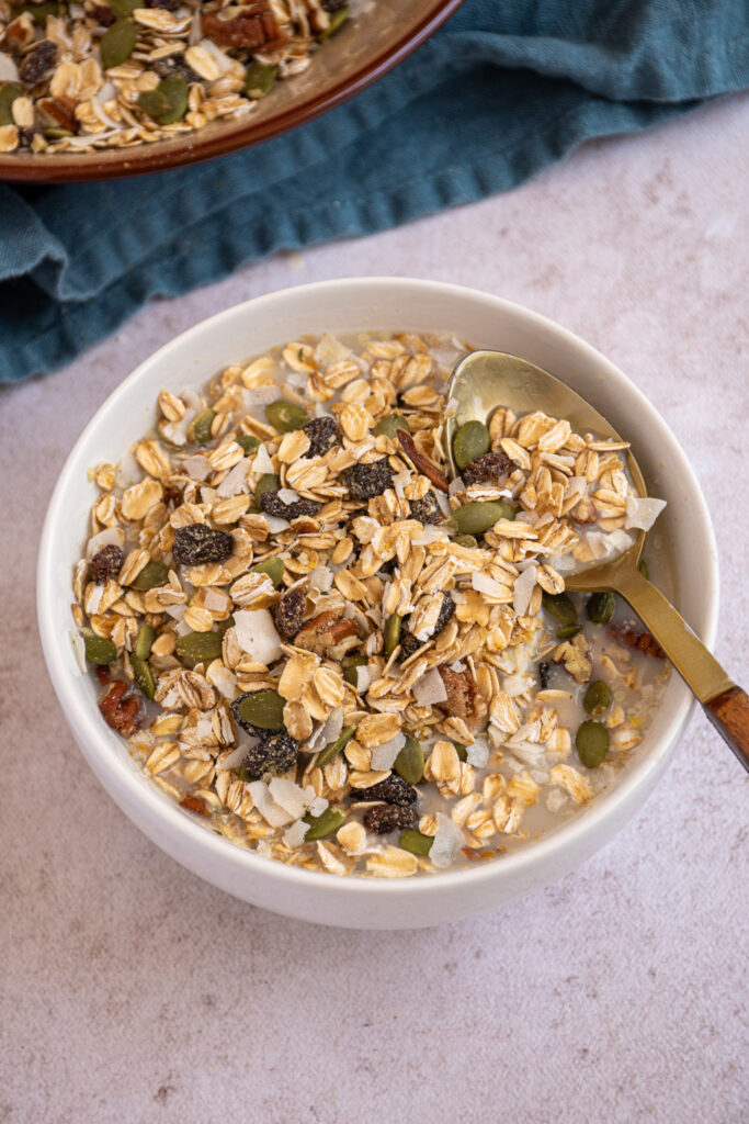 A bowl bowl and gold spoon with homemade muesli.