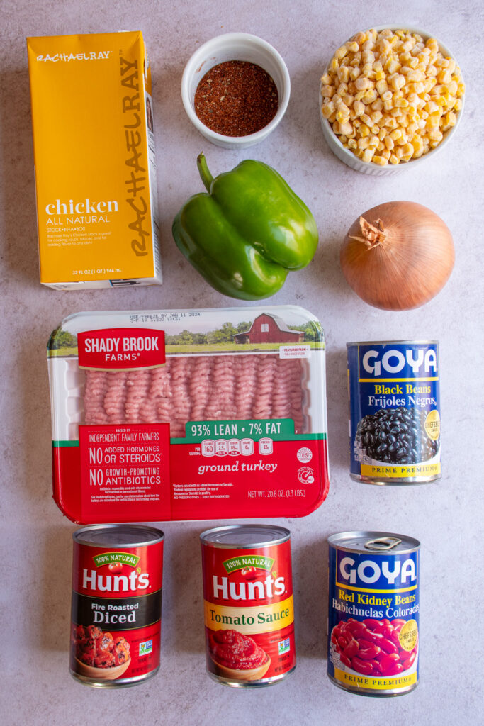 Ingredients to make ground turkey taco soup laid out on a tabletop.