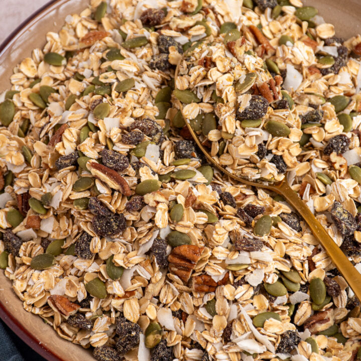 A large brown bowl filled with muesli and a serving spoon.
