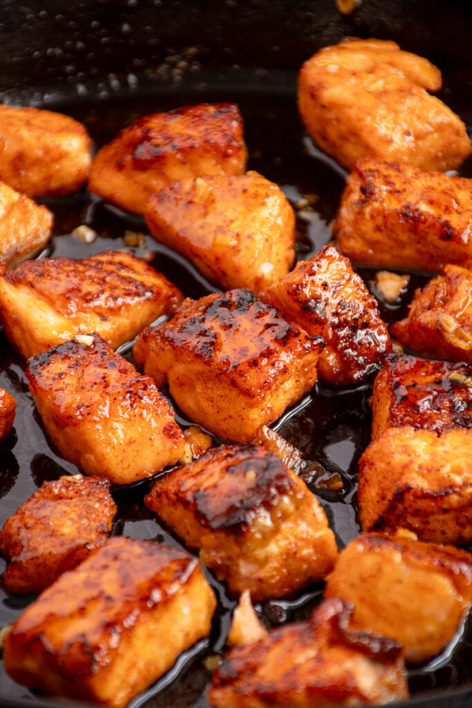 A cast iron pan with honey garlic salmon.