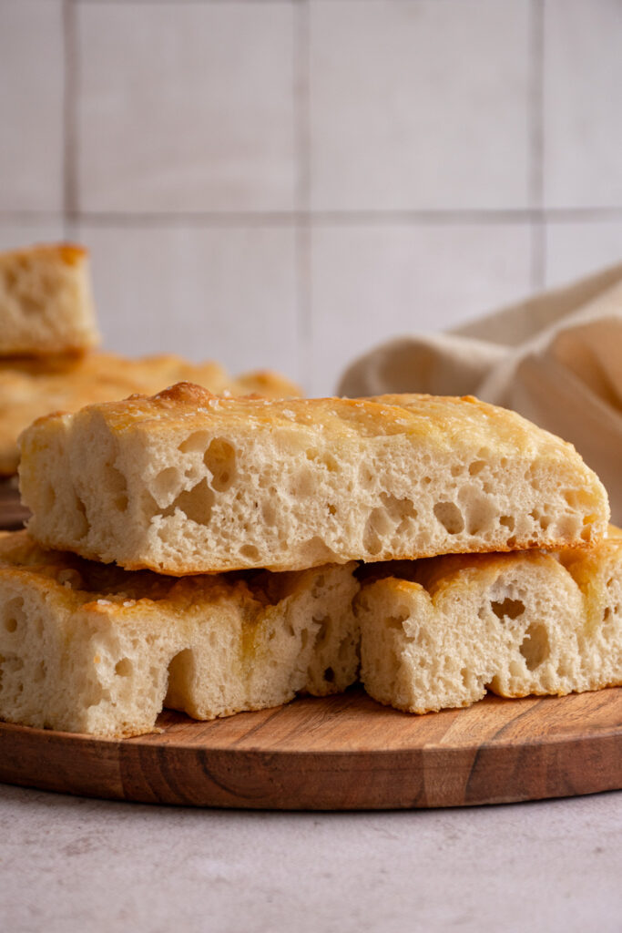 focaccia bread sliced open to reveal an airy inside and a golden brown outside.