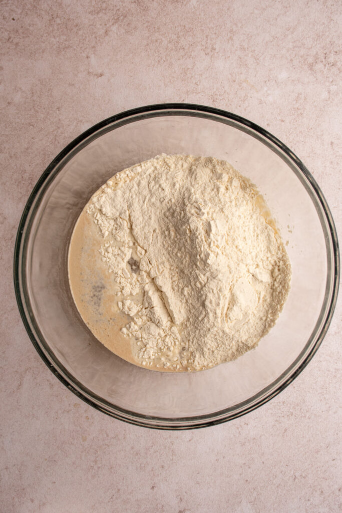 Adding flour to the focaccia dough.