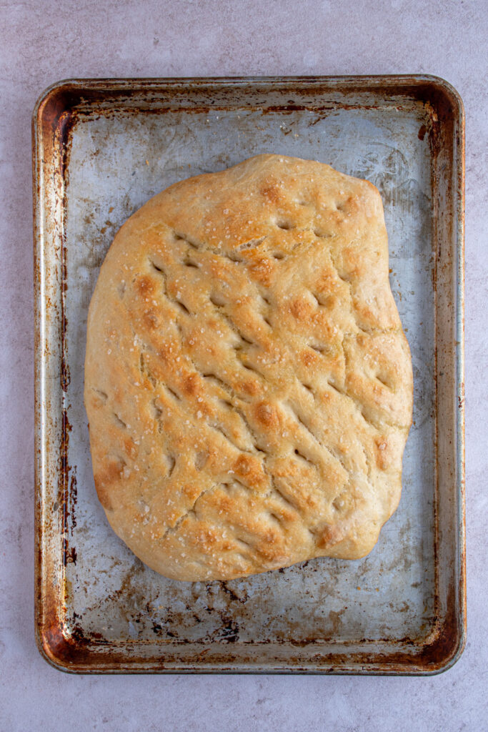 Freshly baked focaccia bread on a sheet pan.