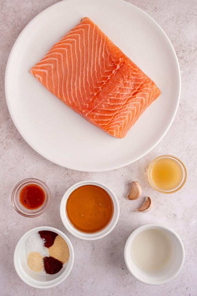 Ingredients needed to make honey garlic salmon bites on a tabletop.