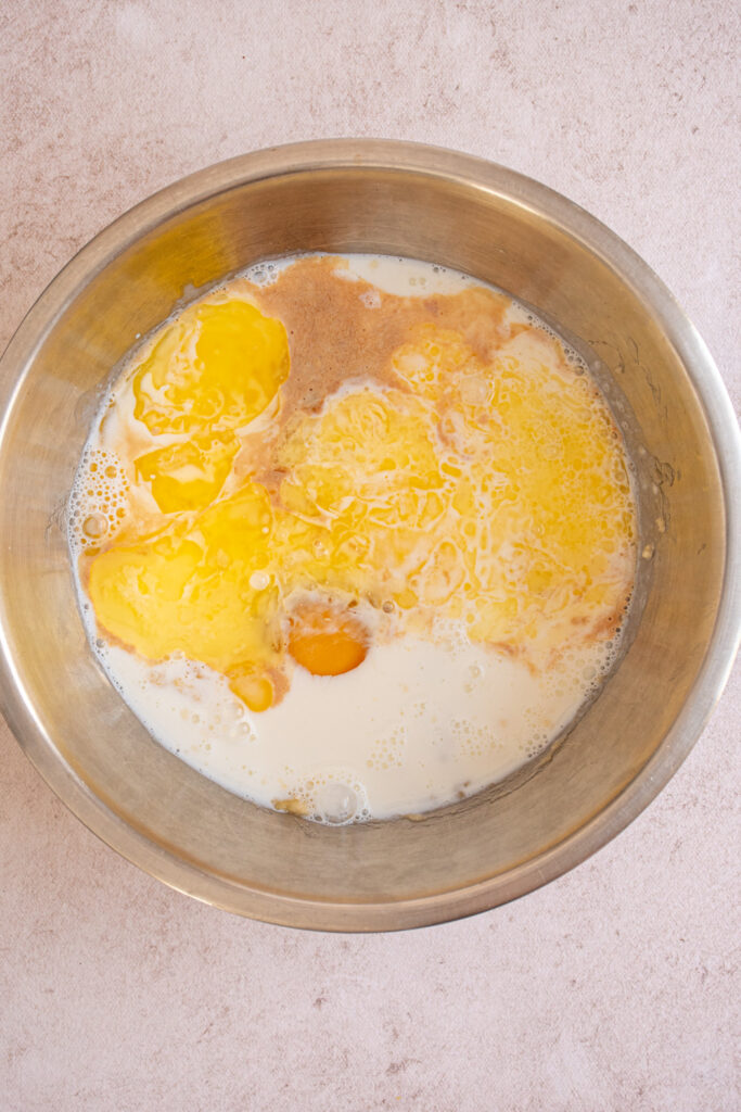 All the wet ingredients in a bowl for making Banana Chocolate Chip Pancakes.