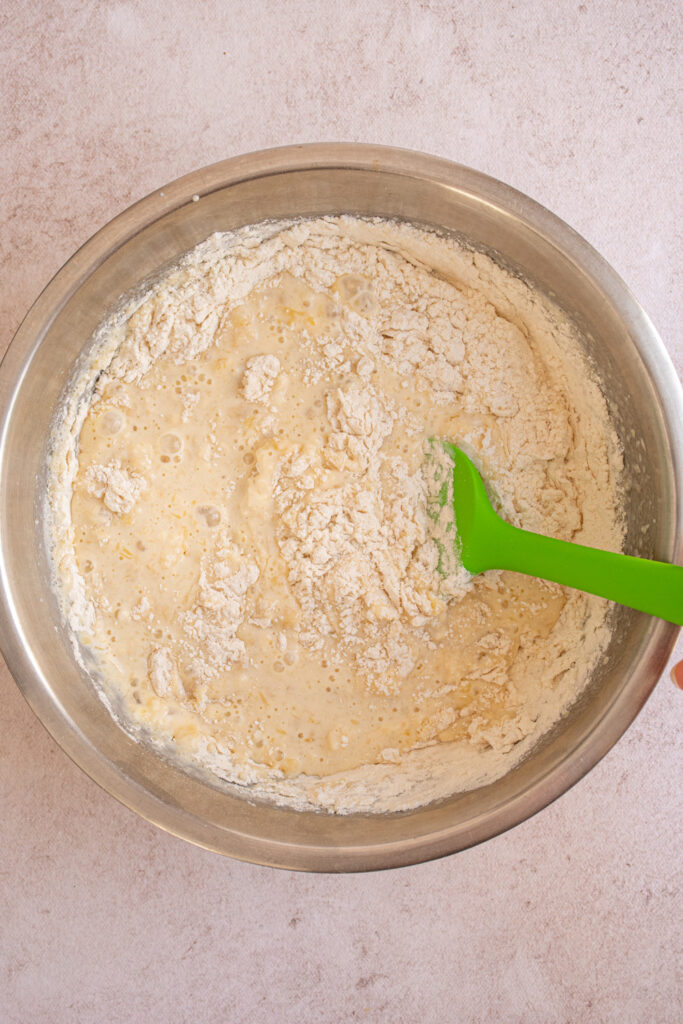 Mixing together the wet and dry ingredients to make Banana Chocolate Chip Pancakes.