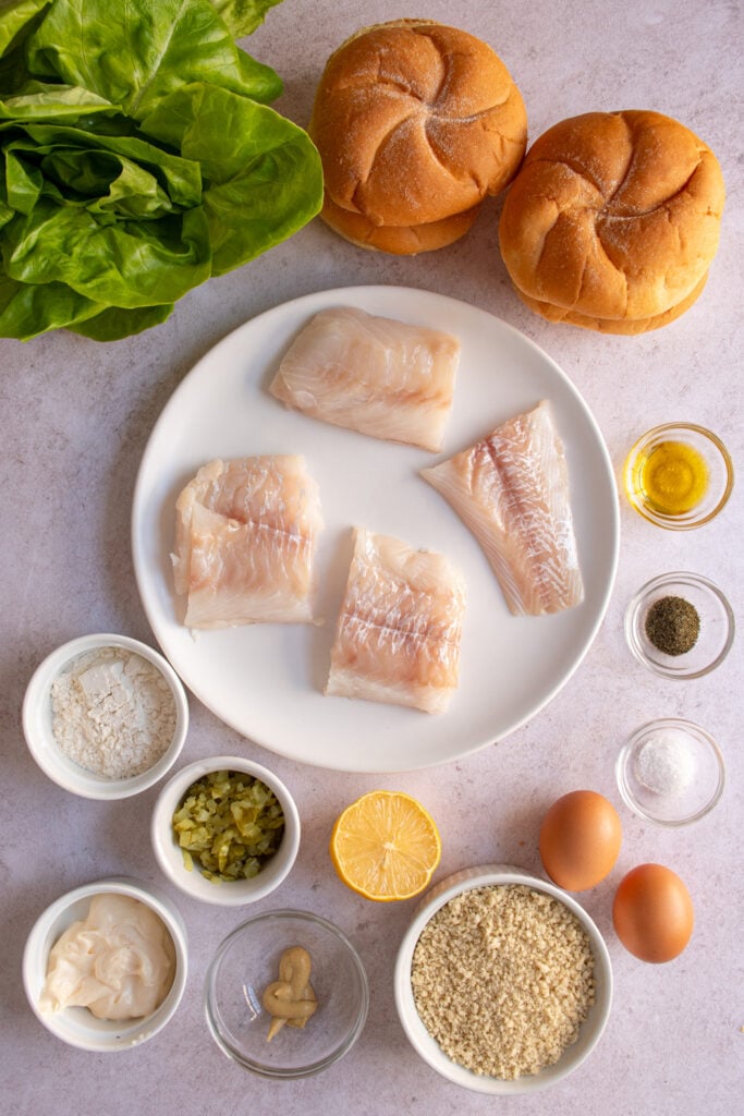 Ingredients needed to make a crispy baked fish sandwich laid out on a table top.