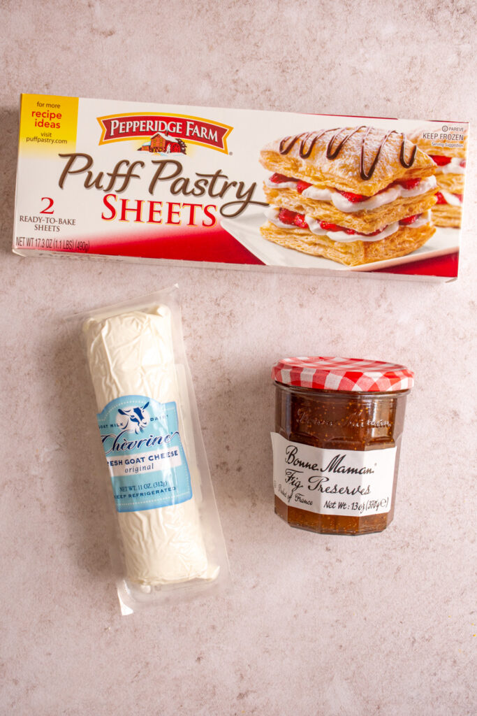 Ingredients for making Fig and Goat Cheese Puff Pastry Pinwheels laid out on a tabletop.