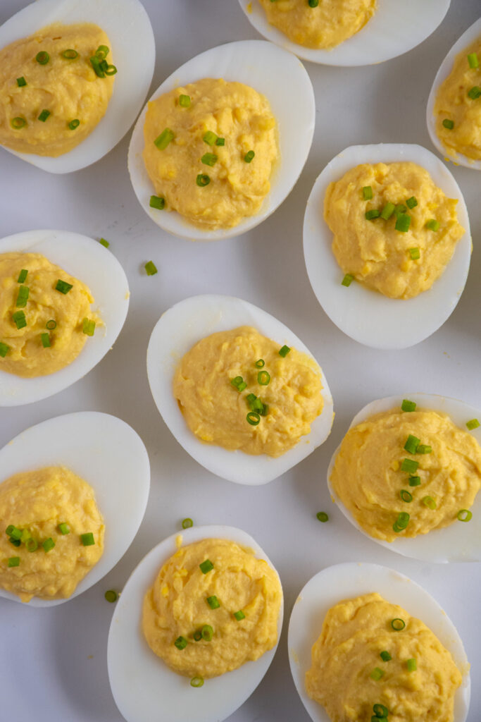 Overhead of a white plate filled with Horseradish Deviled Eggs.