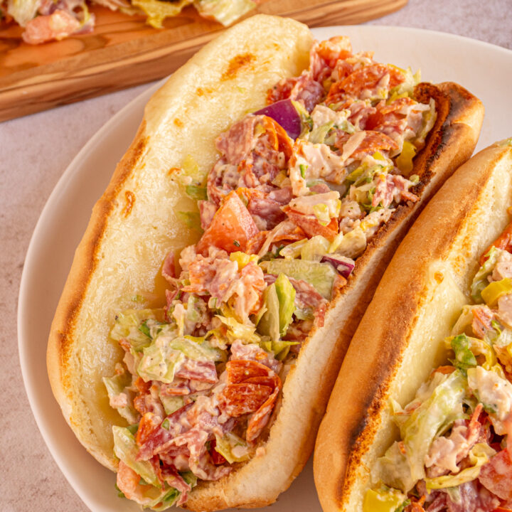 A close up of a Chopped Italian Sandwich on a white plate.