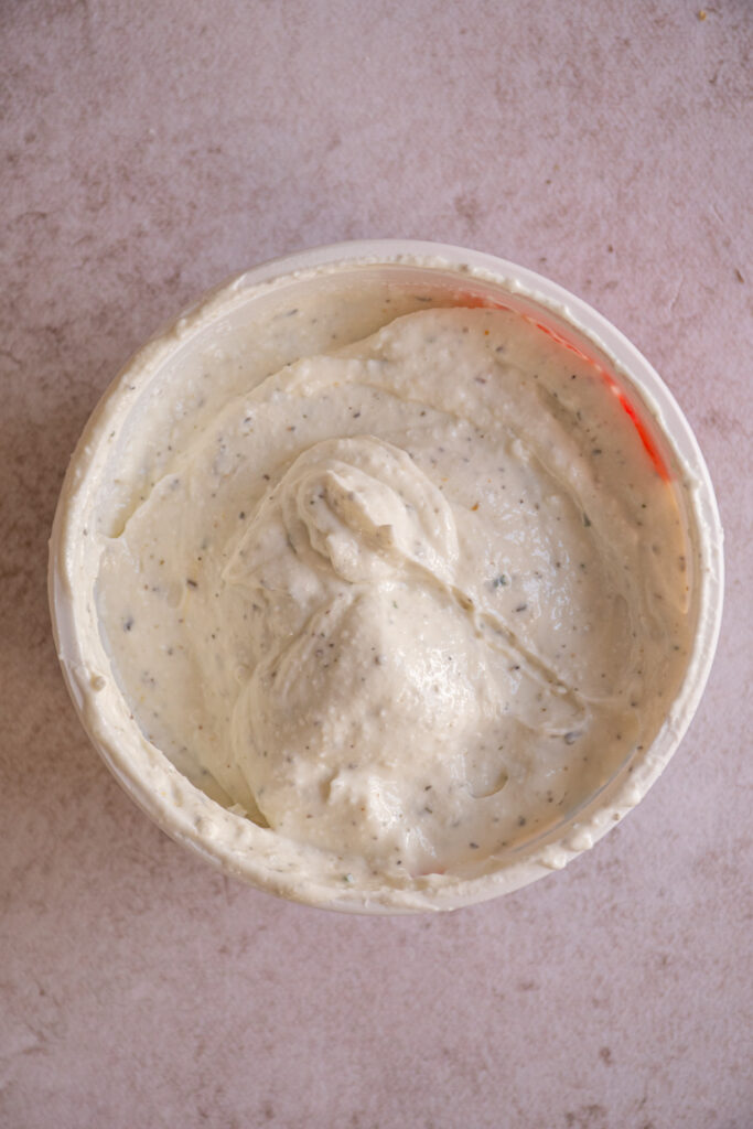 Seasoned and blended cottage cheese in the container.
